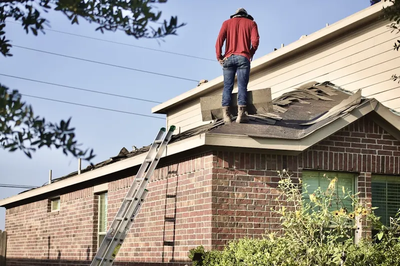 Professional roofer working on a residential roof in Hazeltine